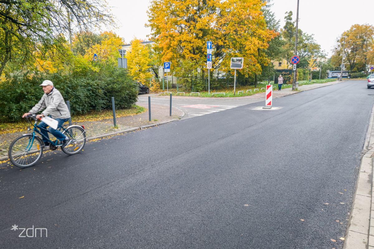 Starszy rowerzysta jedzie po wyremontowanej ulicy
