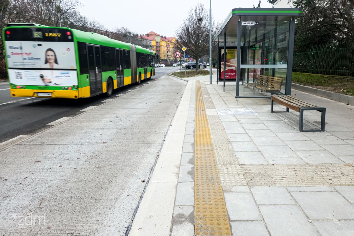 Platforma i wiata przystankowa. Po lewej stronie odjeżdżający autobus.
