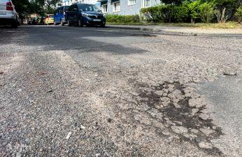 Ubytki na ulicy Pogodnej w tle samochody